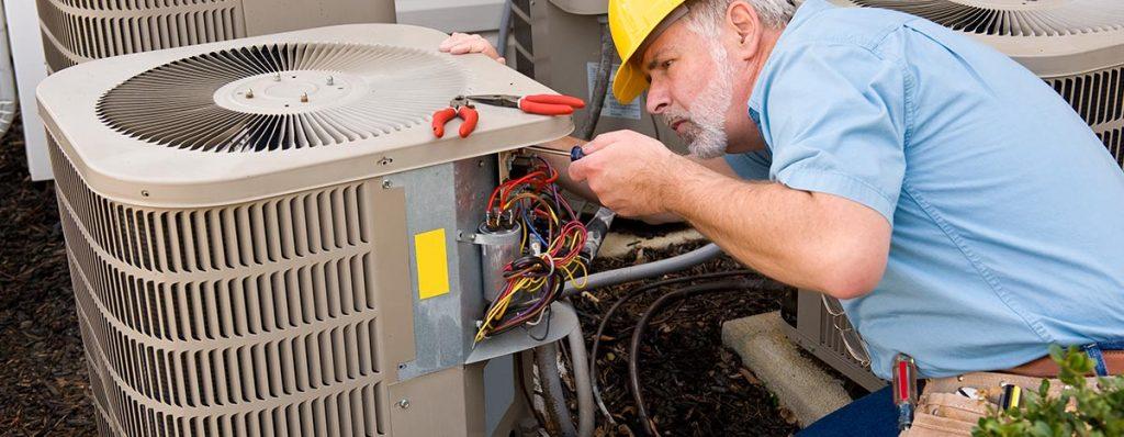 Technician in the middle of a heat pump repair in Lake Helen