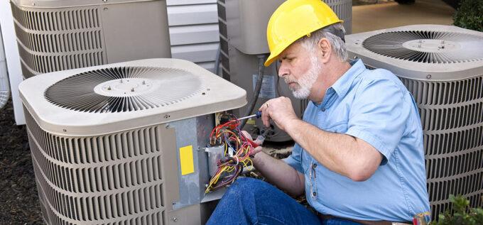 Man repairing an ac unit in Cassadaga, FL